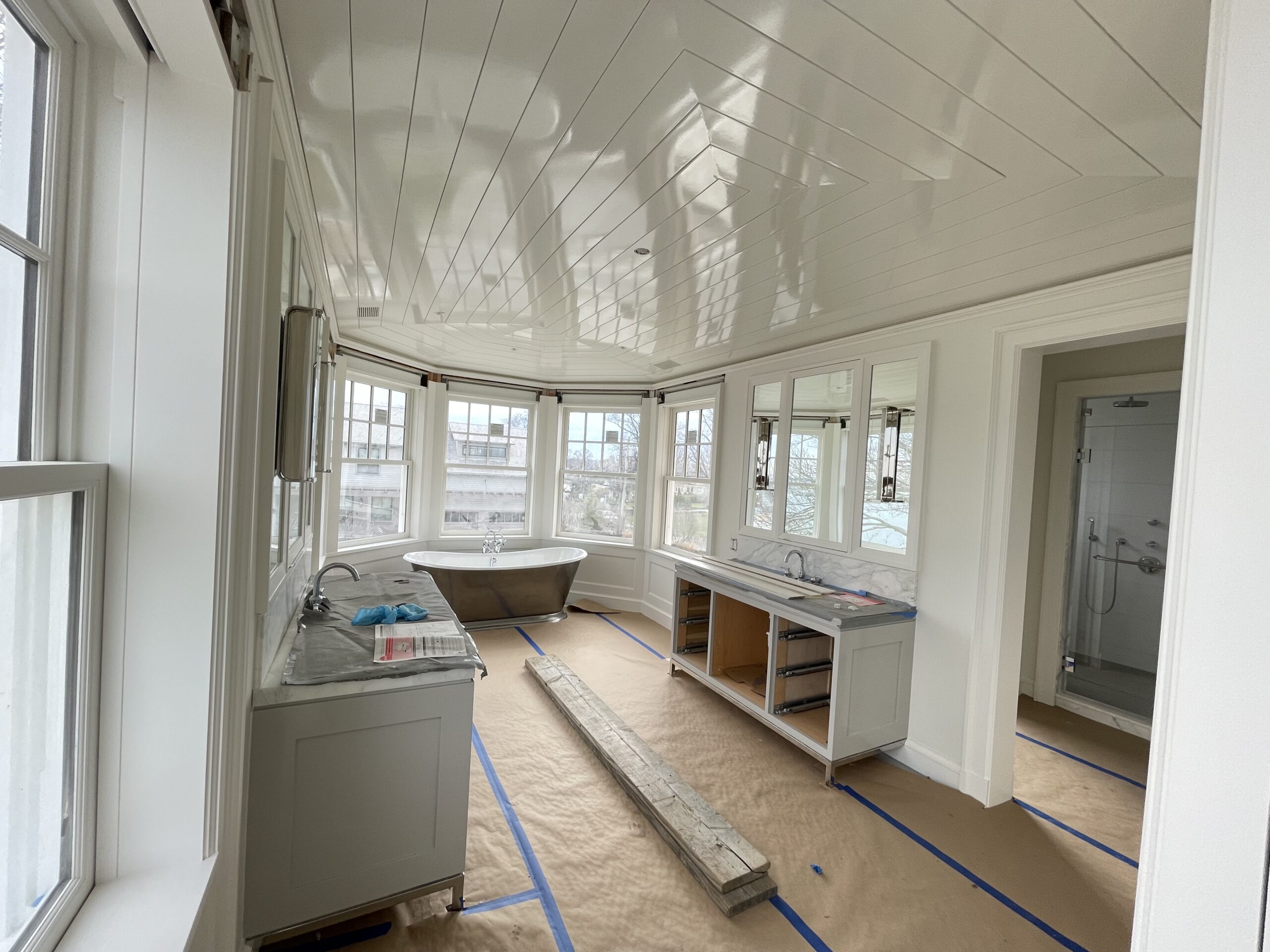 Primary bathroom with a high-gloss white shiplap ceiling and bay-window soaking tub, finished by L&J Painting Group
