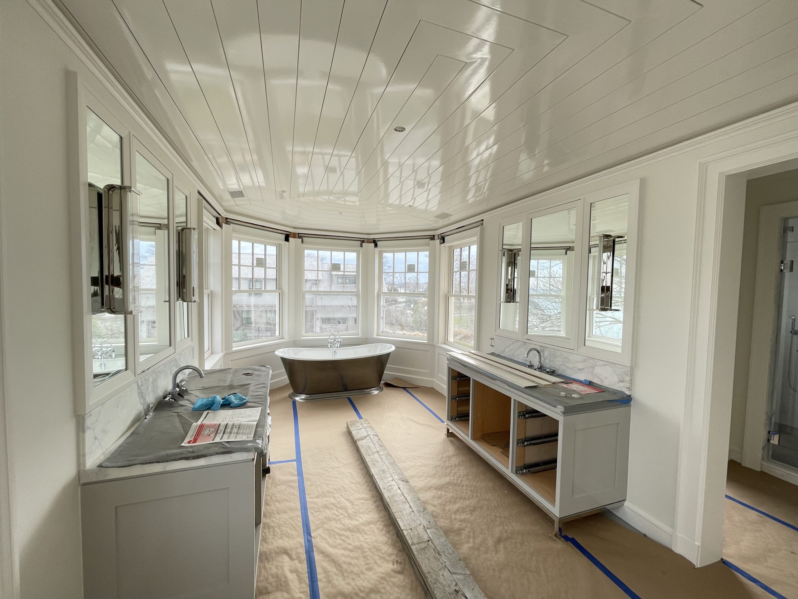 Wide view of a high-gloss white shiplap ceiling finish in a primary bathroom, by L&J Painting Group