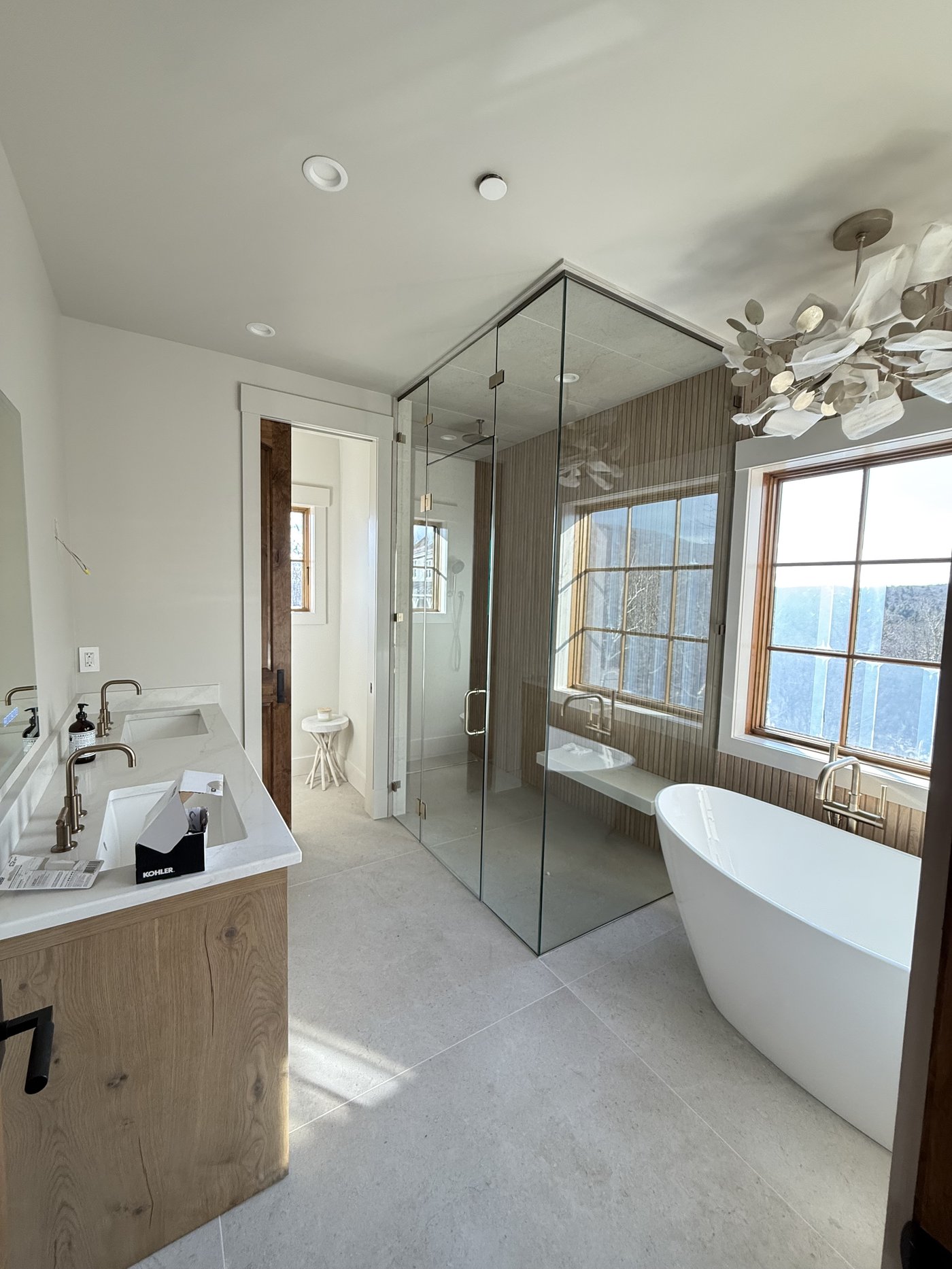 Luxury primary bathroom with freestanding tub and glass shower, finished by L&J Painting Group