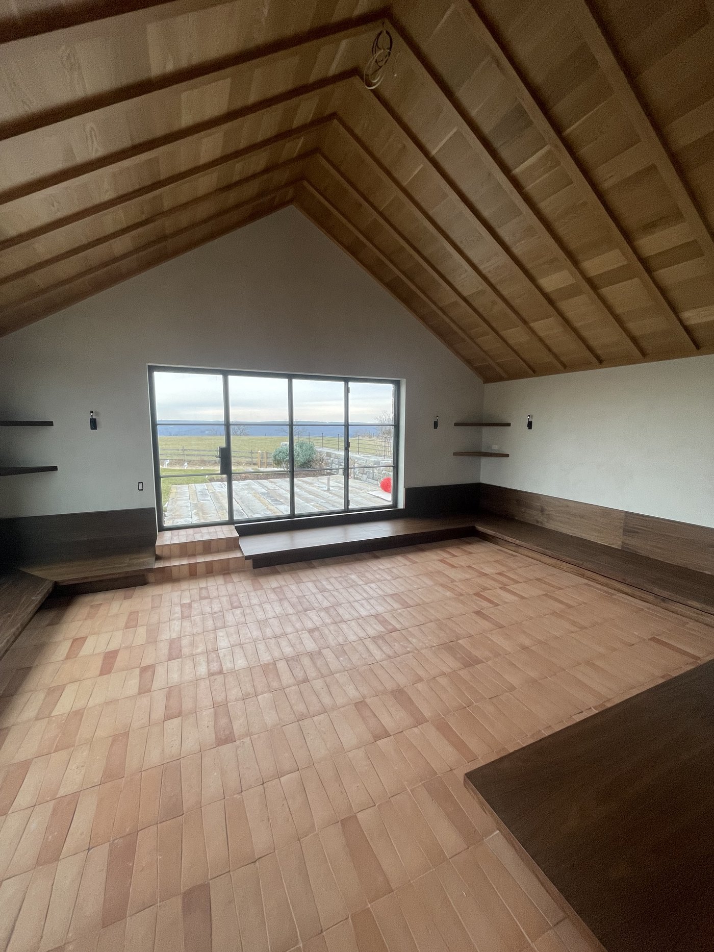 Vaulted loft with herringbone wood floor and ocean view, fine finish work by L&J Painting Group