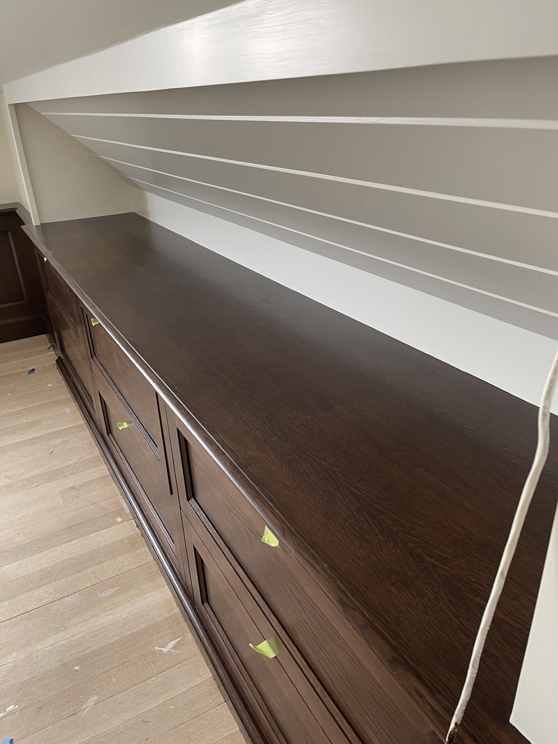 Rich dark walnut stain finish on custom built-in cabinetry, by L&J Painting Group