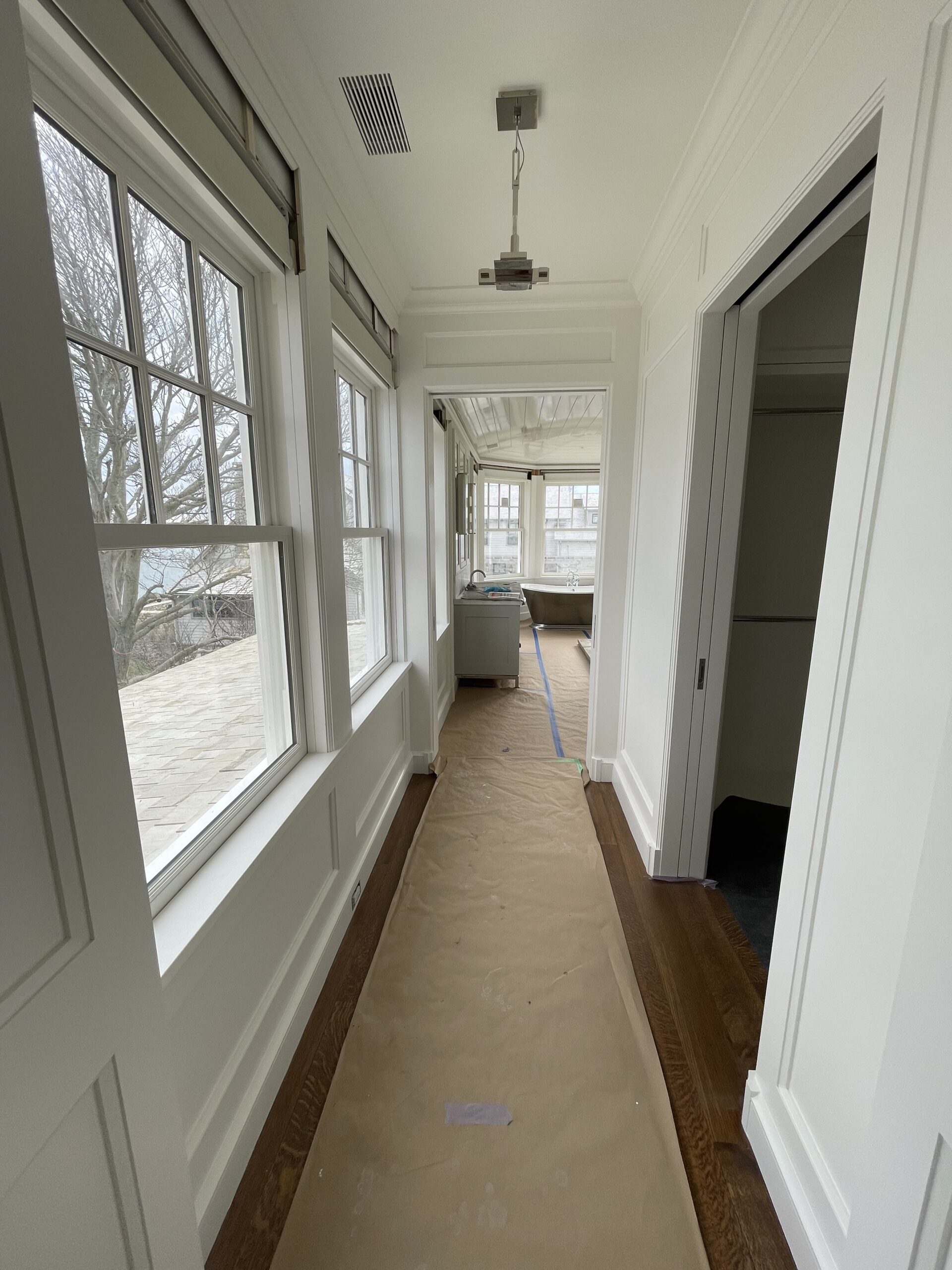 Sun-filled gallery hallway with waterfront views, finished by L&J Painting Group