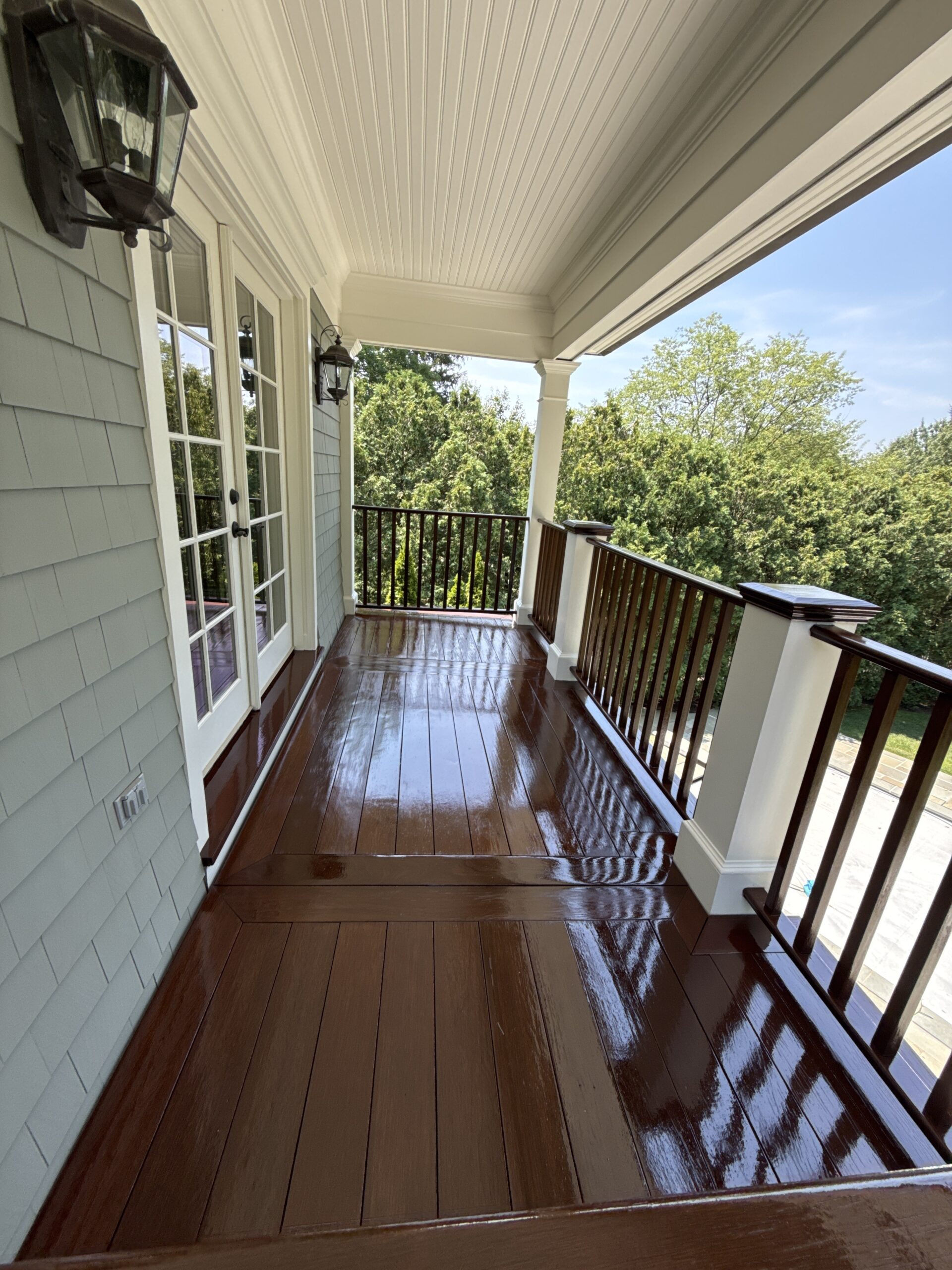 Freshly finished, high-gloss stained deck boards by L&J Painting Group