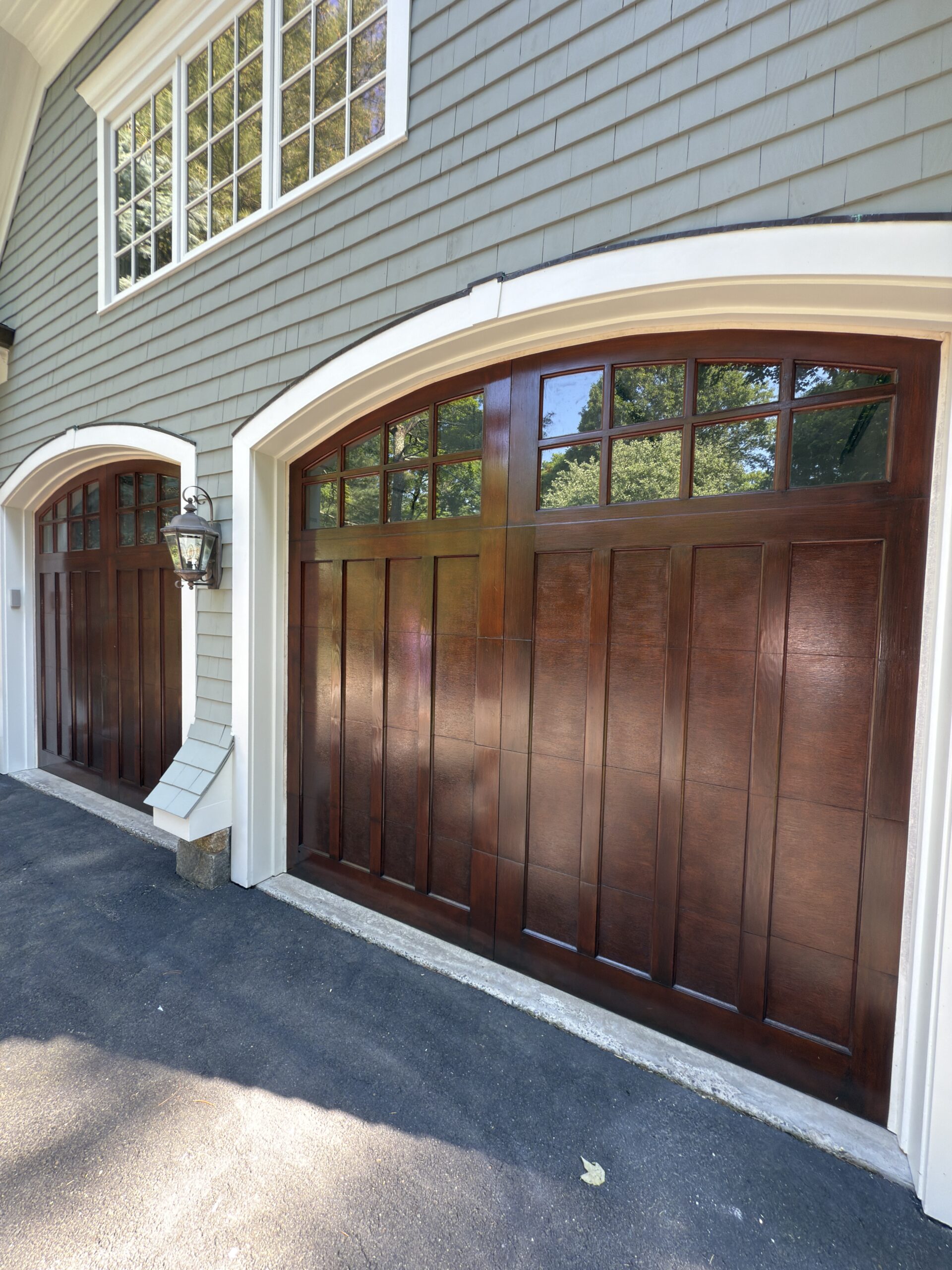 Detail view of finished stained wood garage door paneling by L&J Painting Group